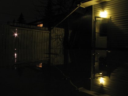Reflection off the patio table in the back yard at night in the rain