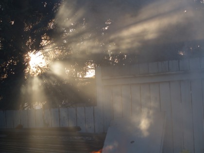 Beams of sunlight piercing fire smoke