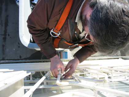 Looking down at Al working on a sign in Red Deer